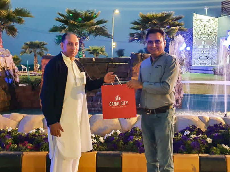 Mr. Kaleem Ullah Gilani Handing over the Goodie Bag to Participant of Tree Plantation Campaign
